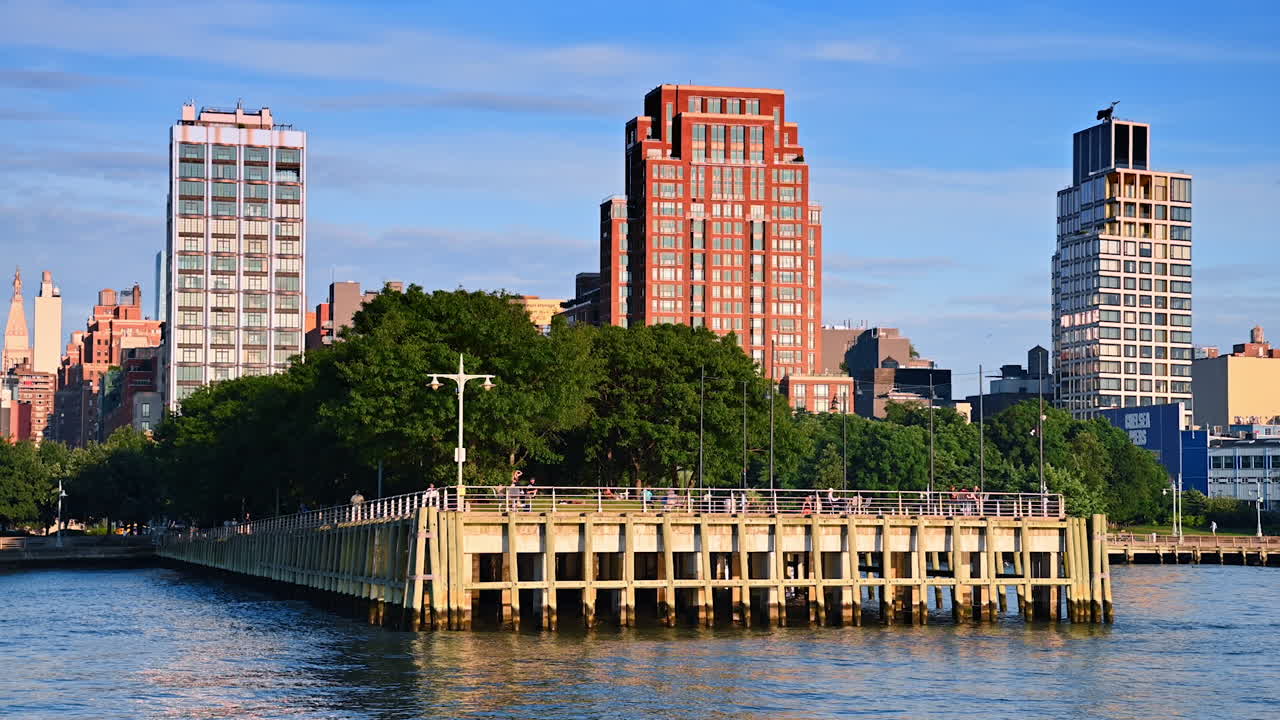 New York, USA, 4 August 2025: Chelsea Piers waterfront with Manhattan buildings. View of Chelsea Piers waterfront and Manhattan residential buildings under clear blue skies
