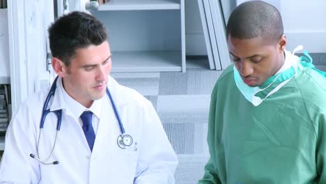 surgeon and doctor talking about work in hospital hall