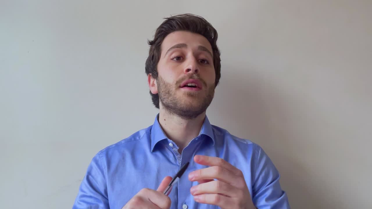 Young Male University Lecturer Answering Question During Video Lesson