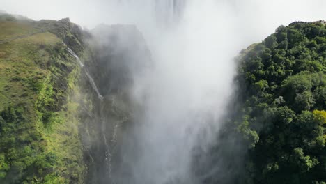 aerial drone view of victoria falls and its rainbows, in between zambia and zimbabwe