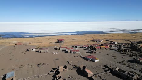 Aerial-of-eco-lodge-in-the-deserted-landscape-of-Salar-de-Uyuni-next-to-Uyuni-Salt-Lake,-Bolivia