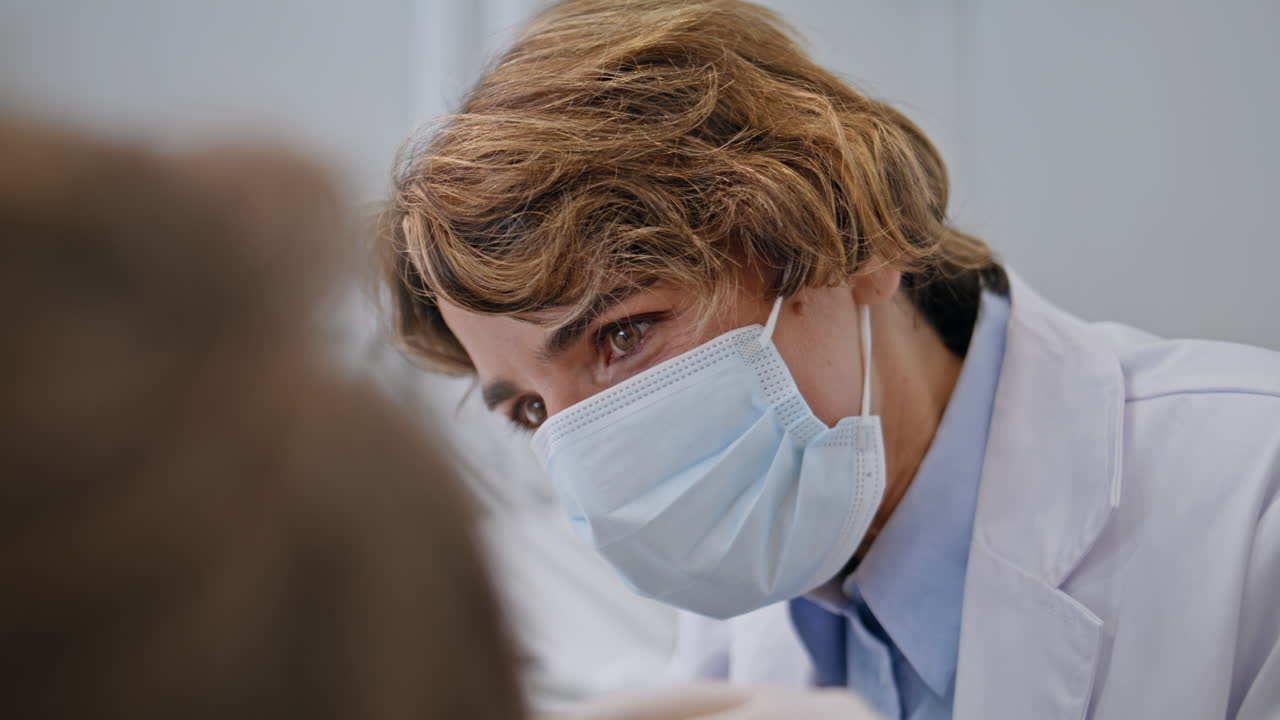 Dentist examining oral cavity patient at dental procedure closeup. Woman doctor