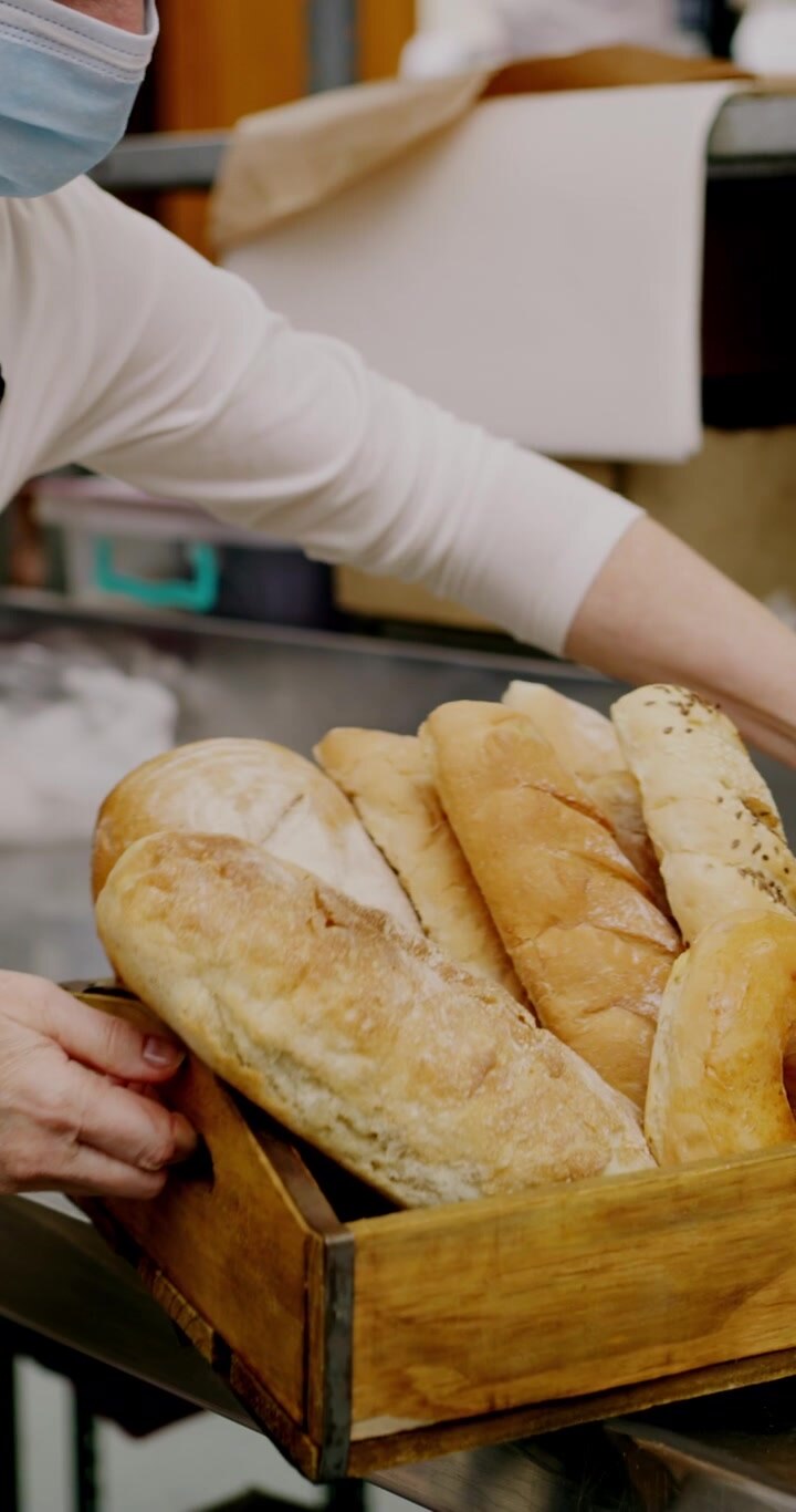 Bakery Staff Checking Inventory and Organizing Fresh Bread