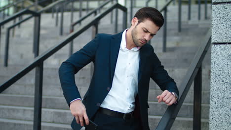 successful businessman smiling at city center