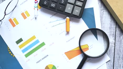 financial graph, calculator and notepad on table