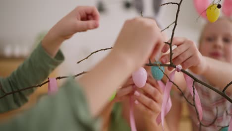 children decorating an easter tree