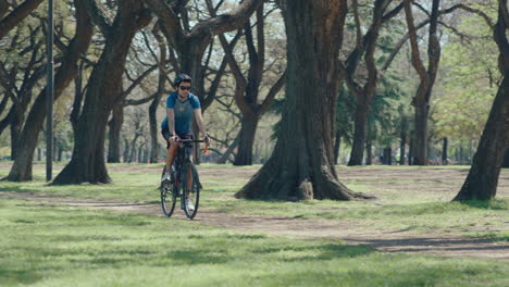 young cyclist biking in the park during weekend day