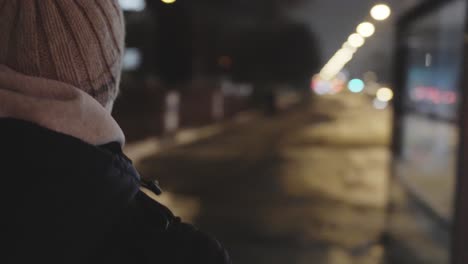 young man casual stroll in city streets at nighttime in slow motion