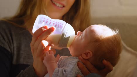 mother feeding milk to her baby boy 4k