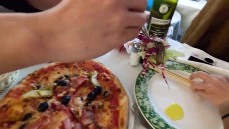 friends sharing salad and pizza at a table