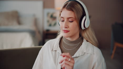 young woman in headphones, looking at a smartphone