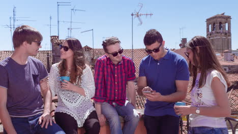 friends enjoying a sunny rooftop view