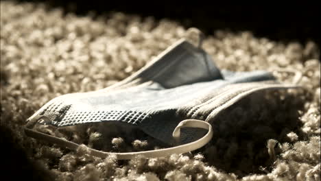 sunlight on protection mask on living room floor, strong coronavirus pandemic concept