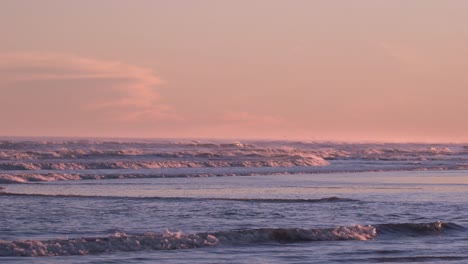 dramatic sky during sunset over ocean with rolling waves in new jersey