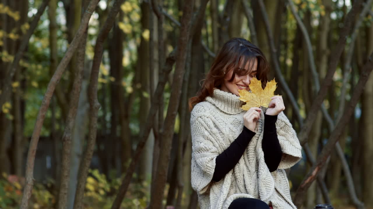 Beautiful female dreaming in the autumn park. Cheerful beautiful girl outdoors on beautiful fall day