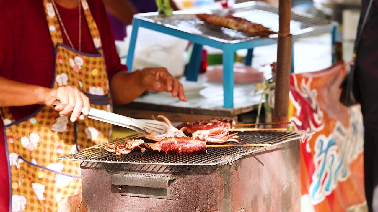 Vendor grilling squid at a street market