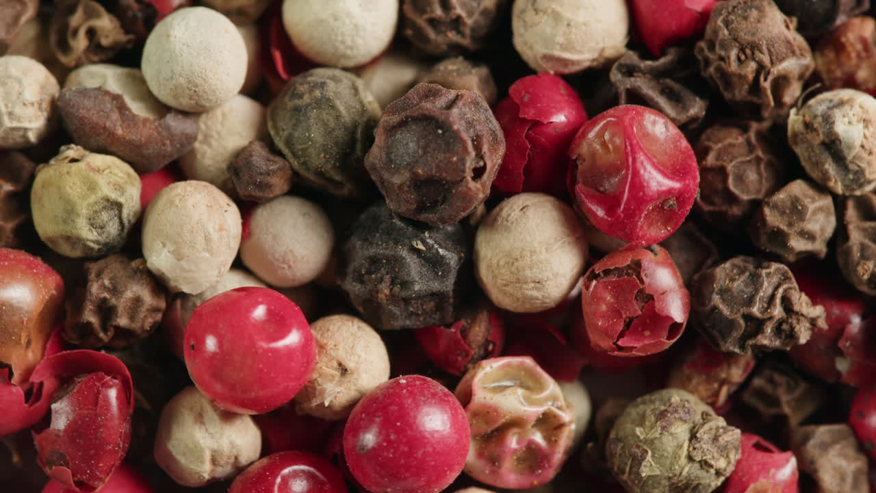 Close-Up of Mixed Peppercorns: Red, White, Black, and Green Spices