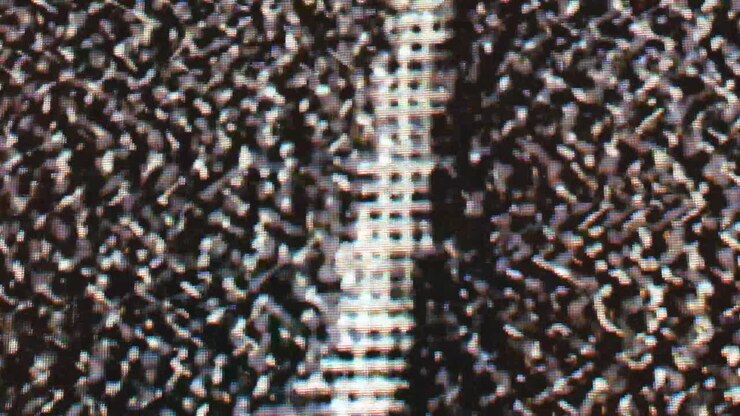 Close-up of retro LCD CRT screen during a glitch overlay pattern