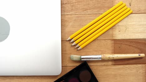 close-up of laptop with various stationery