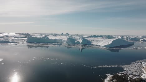 drone over sea and ice of ilulissat icefjord