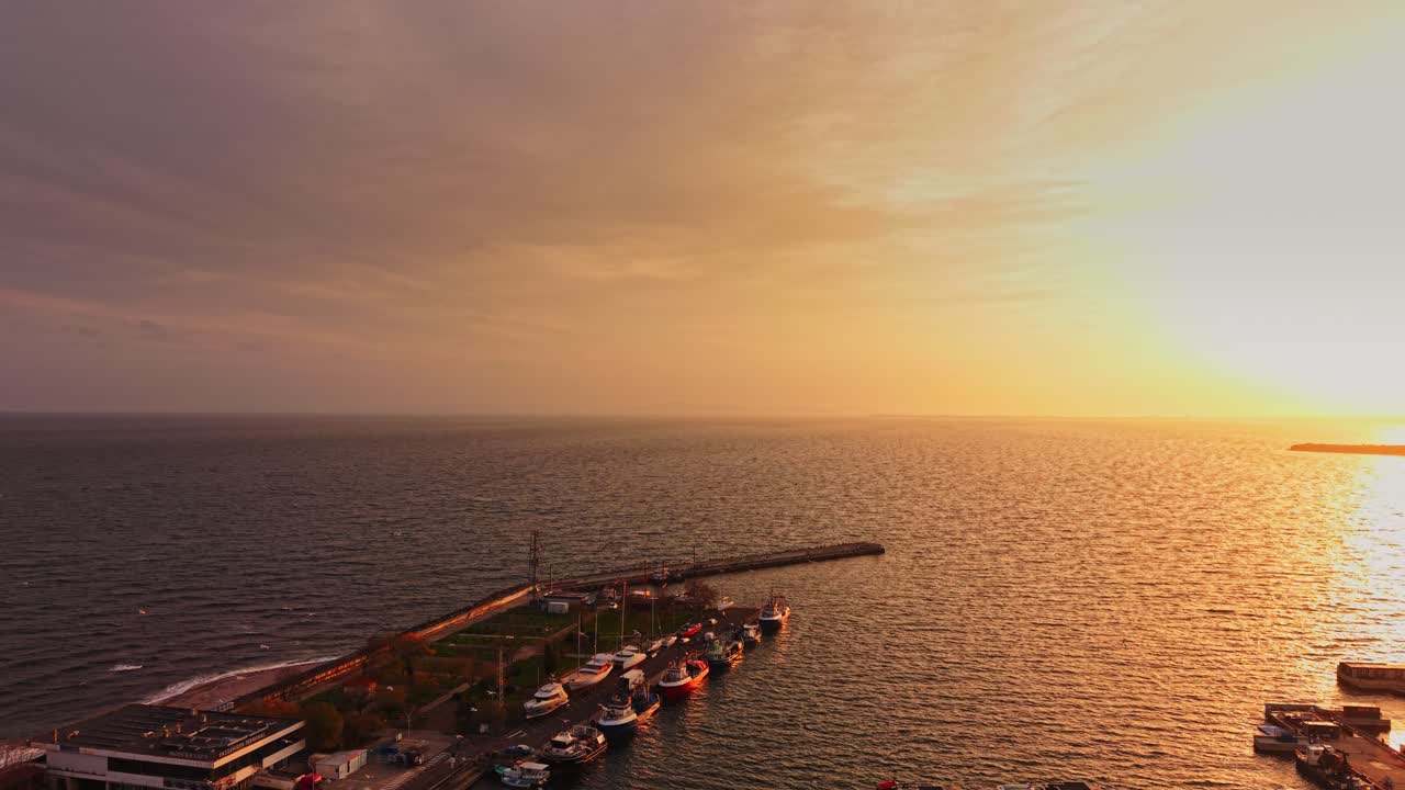 Sunset over the marina in Nesebar, Bulgaria with boats and sea