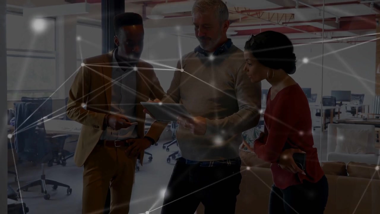 Vertical video: Tilting center man in sweater reviewing tablet in office with overlay and phone
