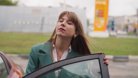 curious woman got out of car looking up at office building