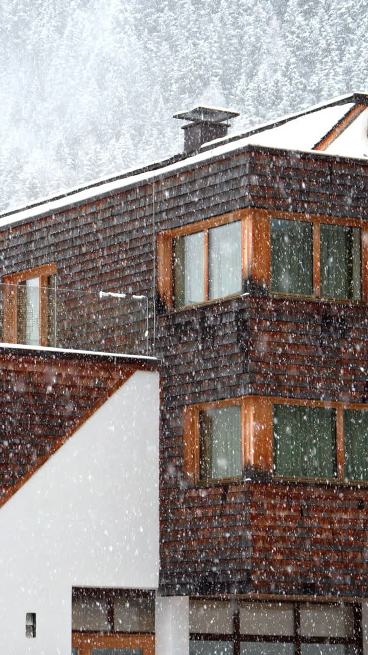 View of multiple ski cabins while snowing in the Dolomites, Italy. Vertical