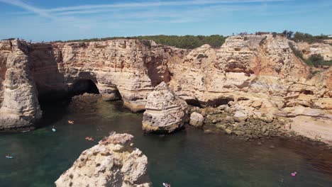 Flying-over-Praia-Da-Marinha--in-Algarve,-Portugal