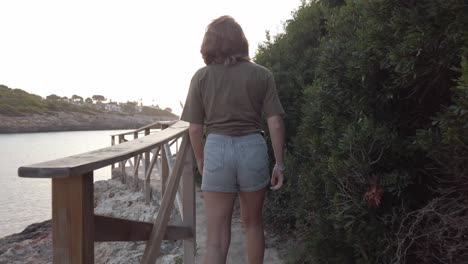 girl walking at sunrise on a beach