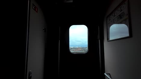 looking through a train window at urban scenery with cloudy weather in japan.