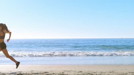 fit woman jogging in the beach 4k