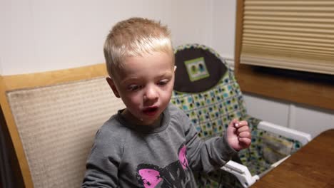 toddler eating his breakfast with his hands