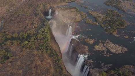 aerial view of zambezi river's famous victoria falls with rainbow