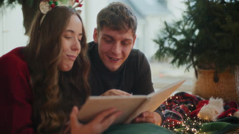 heterosexual couple watching photo album at home