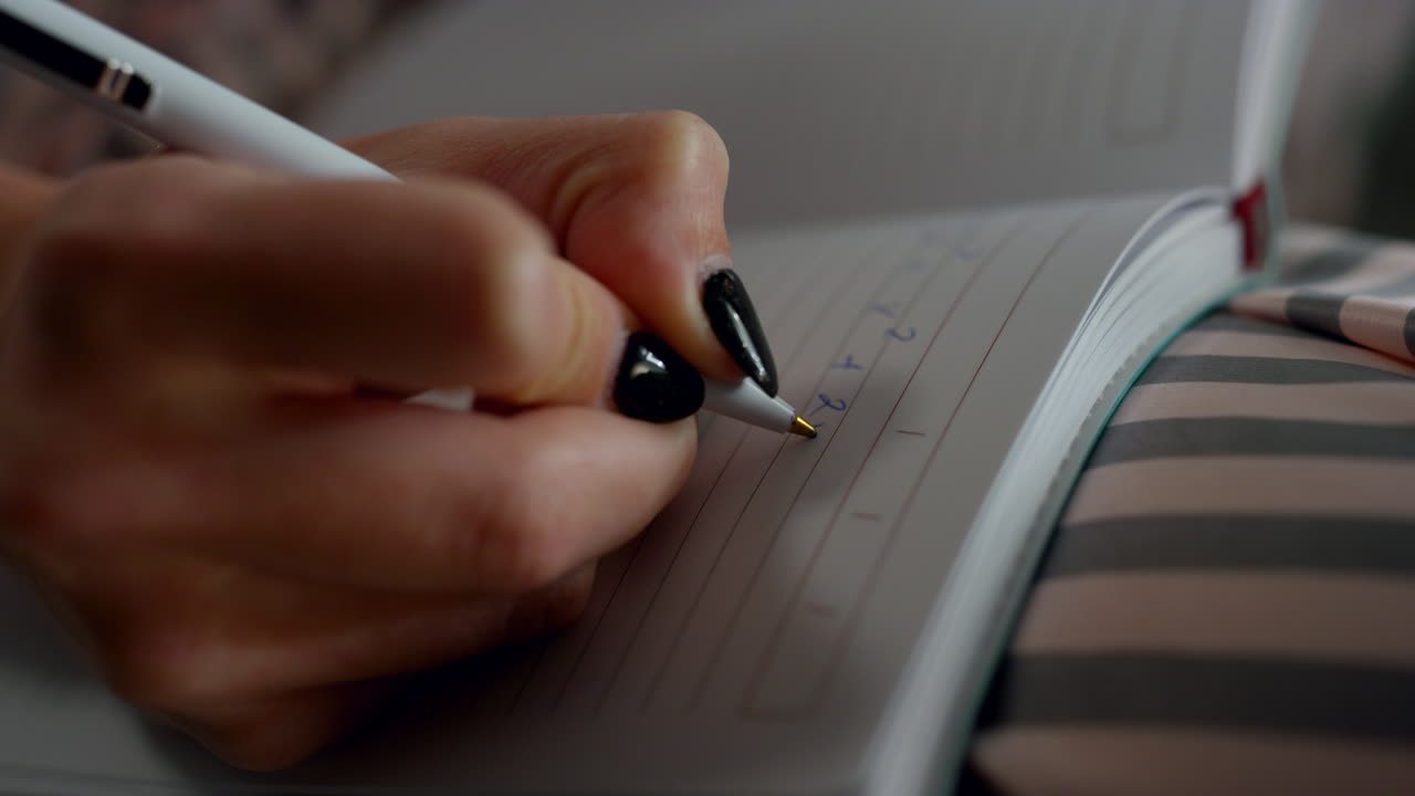Closeup hand writing notepad at home. Unknown student studying maths remotely