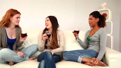 Lovely-friends-chatting-while-sitting-on-couch