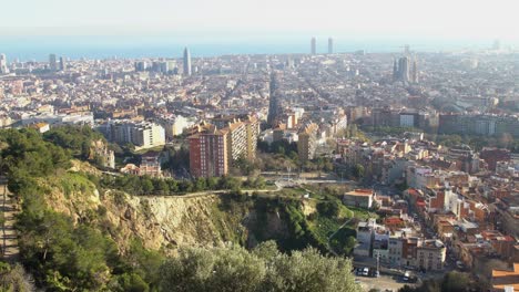 handheld shot looking down at the city of barcelona during the start of golden hour