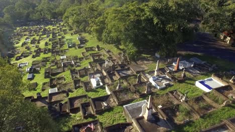 aerial drone descending shot over cemetery to reveal broken grave