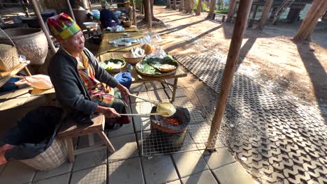 person cooking rice using traditional methods outdoors