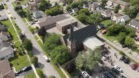 aerial push in tilt down above st catharines church steeple and grey roof top covering