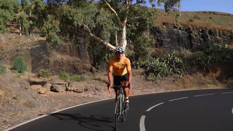 a cyclist, a man, takes to an unoccupied road in the morning on his road bike for outdoor exercise. the slow-motion footage encapsulates the thrill of extreme sports