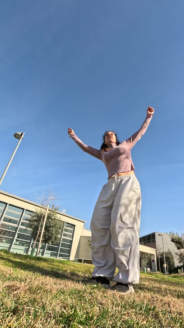 Young woman dancing freestyle in a park