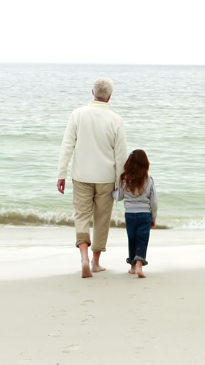 Grandfather and granddaughter walking together
