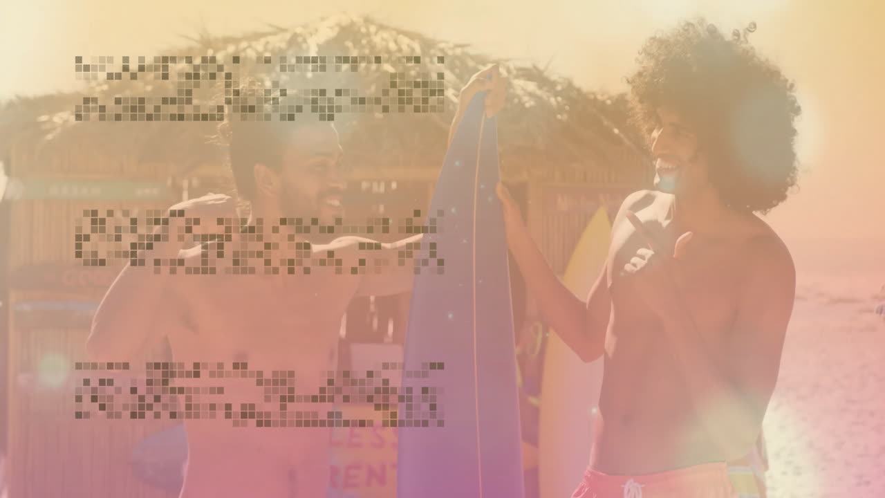 Holding surfboards on beach, two men in animation under warm sunlight