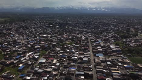 aerial flying back and tilting up over big favela in buenaventura, colombia