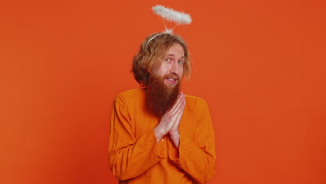 portrait of smiling shy angelic caucasian man with angel halo nimb over head positive love emotions