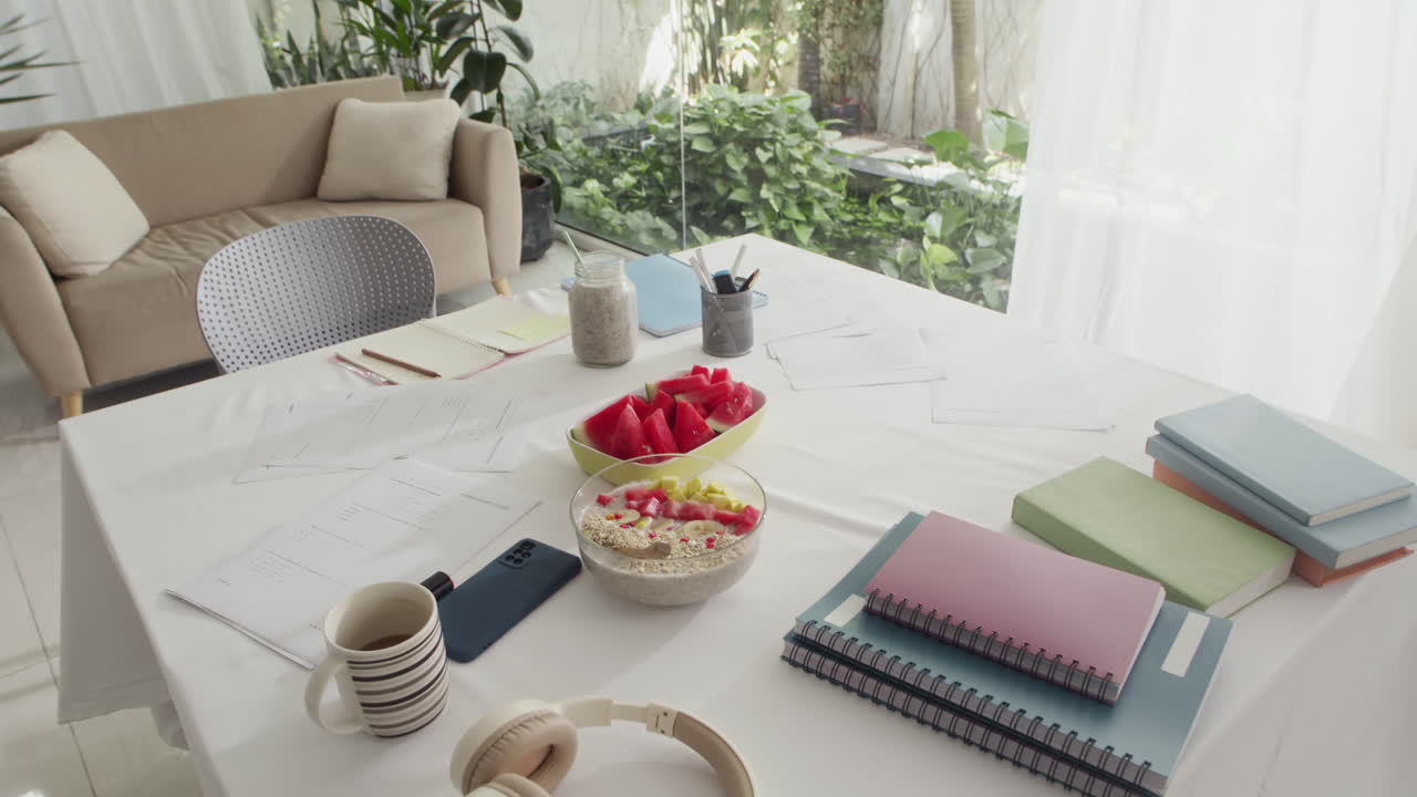 Table with Studying Materials, Gadgets and Snacks