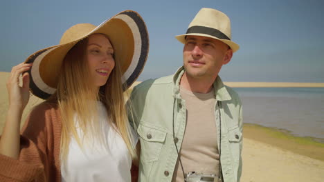 Happy-couple-walking-on-beach-together