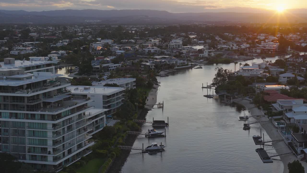 Drone footage captures Gold Coast's Broadbeach canals during sunset, highlighting modern architecture and serene waterways